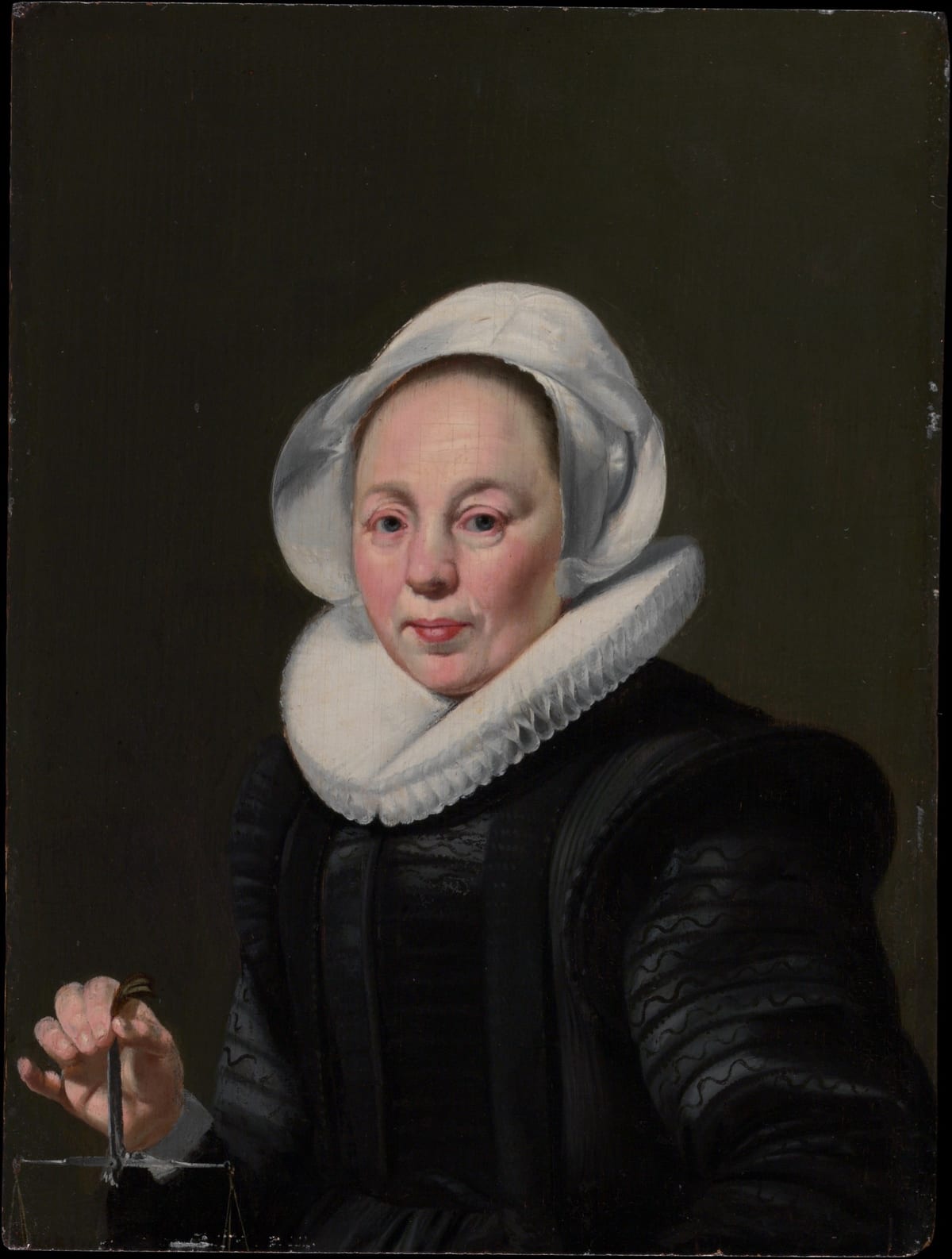 Portrait en buste d'une femme du Siècle d'or hollandais tenant une balance, symbole de mesure et de juste pesée.